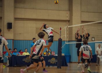 Salon voleybolu maçında file önünde yükselerek smaç vuran oyuncu.
