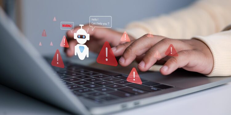 Laptop klavyesi üzerinde eller ve etrafta görünen kırmızı uyarı ikonları