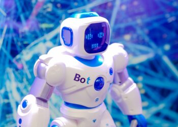 Mavi arka plan önünde duran, üzerinde 'Bot' yazan küçük robot.